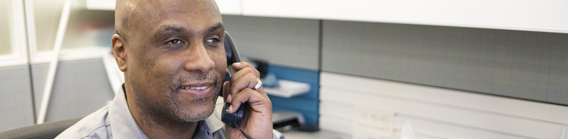 close up of blind man listening on phone.